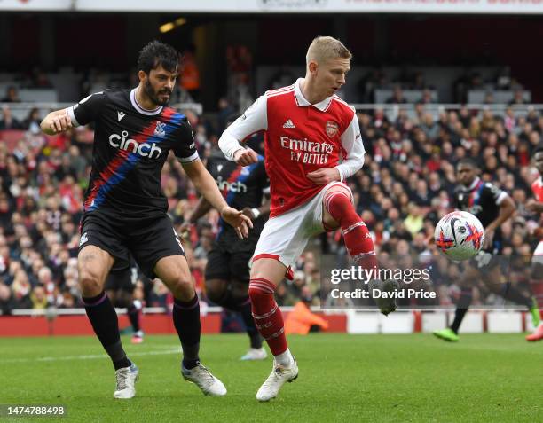 Oleksandr Zinchenko of Arsenal controls the ball under pressure from James Tomkins of Palace during the Premier League match between Arsenal FC and...