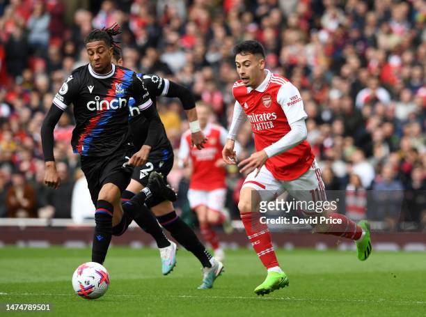 Gabriel Martinelli of Arsenal takes on Michael Olise of Palace during the Premier League match between Arsenal FC and Crystal Palace at Emirates...