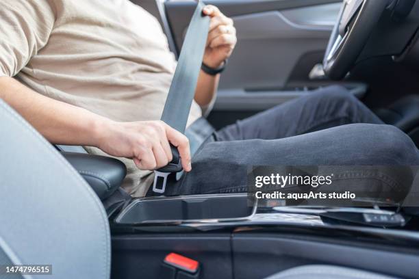 putting on safety seatbelt - seat belt stock pictures, royalty-free photos & images