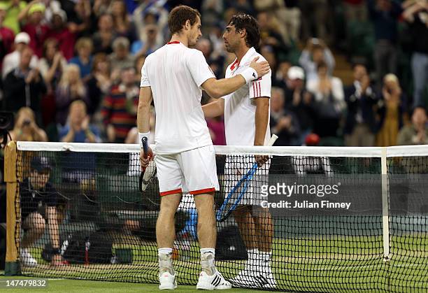 Andy Murray of Great Britain is congratulated by Marcos Baghdatis of Cyprus after his Gentlemen's Singles third round match on day six of the...