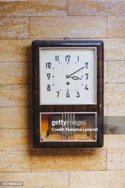 an antique clock is hanging on the wall - antique clock stock pictures, royalty-free photos & images