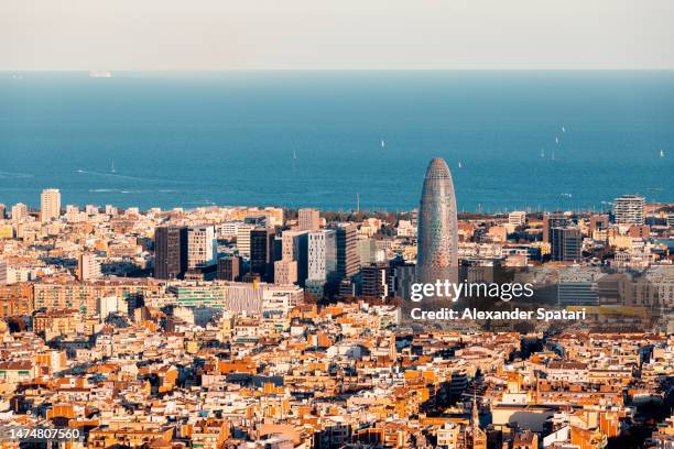 modern skyscrapers of 22@ technological district against mediterranean sea in barcelona, spain - barcelona españa fotografías e imágenes de stock