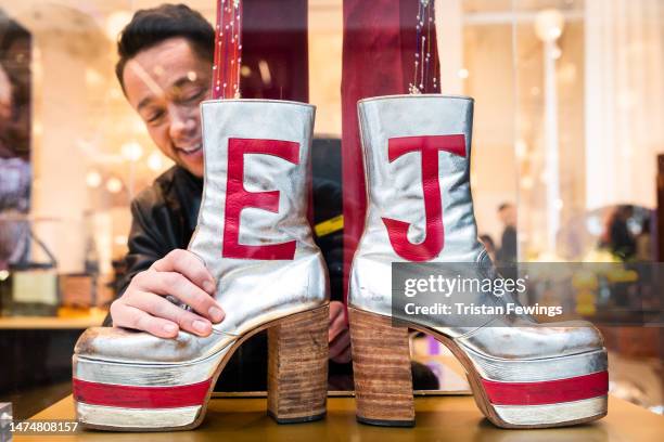 Finishing touches are made to an archive costume worn by Elton John at the launch of 'Elton John at The Selfridges Corner Shop' at Selfridges on...