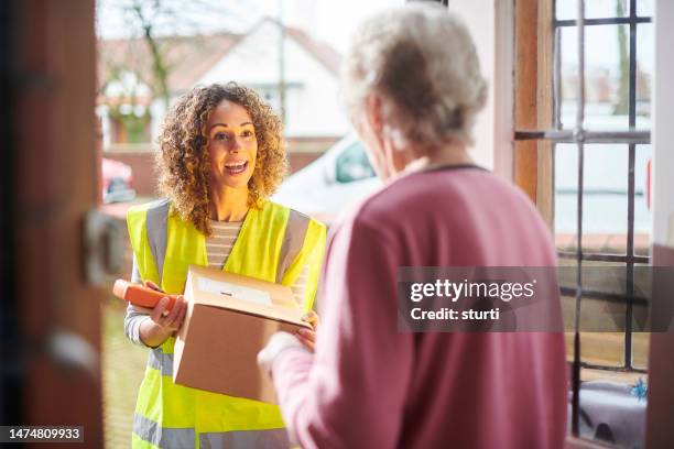 parcel for senior woman - mailman stock pictures, royalty-free photos & images