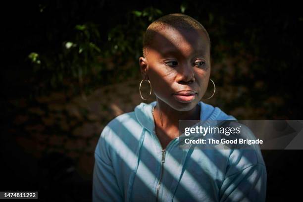 thoughtful portrait of cancer survivor outside on sunny day - survivers stock pictures, royalty-free photos & images