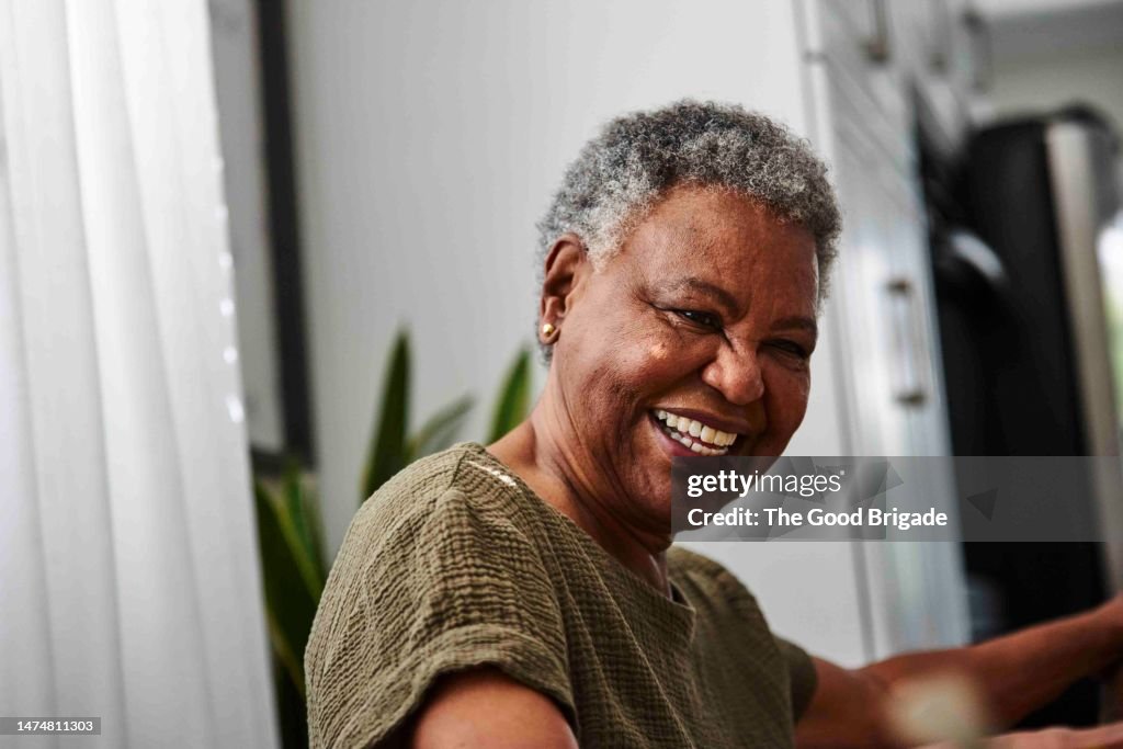 Portrait of cheerful senior woman at home