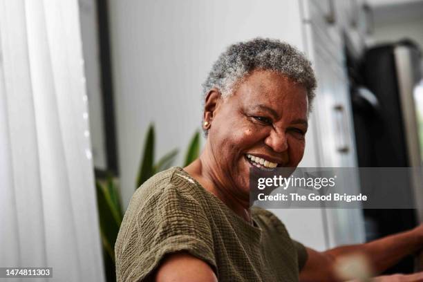 portrait of cheerful senior woman at home - mannerism stock pictures, royalty-free photos & images