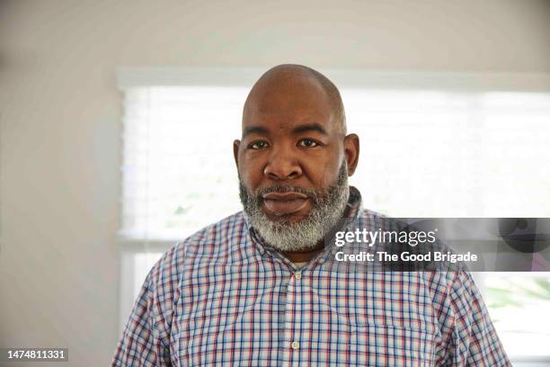 portrait of mature man with shaved head at home - blank expression stock pictures, royalty-free photos & images