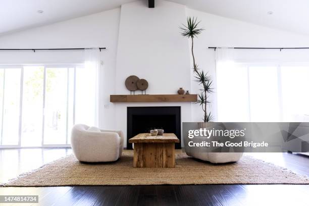 armchairs and coffee table on carpet in living room - mantelpiece stock pictures, royalty-free photos & images