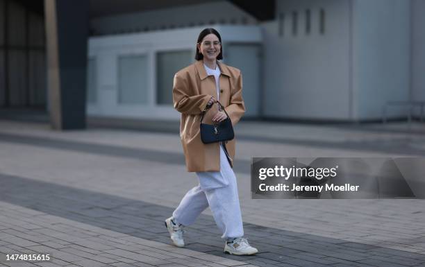 Maria Barteczko seen wearing Ray-Ban gold round retro glasses, Balenciaga gold earrings, Source Unknown light brown oversized leather jacket, Arket...