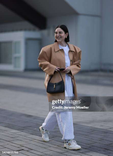 Maria Barteczko seen wearing Ray-Ban gold round retro glasses, Balenciaga gold earrings, Source Unknown light brown oversized leather jacket, Arket...