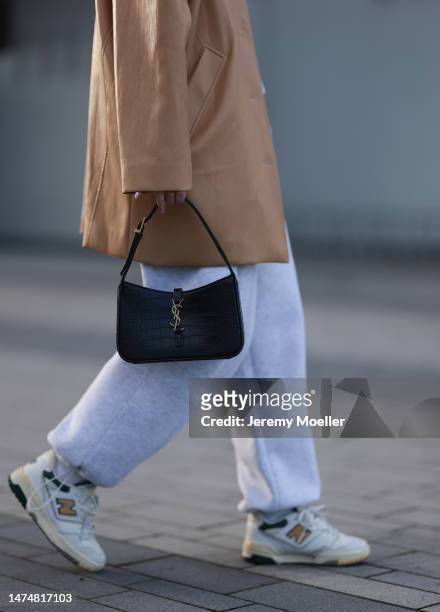 Maria Barteczko seen wearing Source Unknown light brown oversized leather jacket, ASOS grey jogging cargo pants, New Balance 550 white leather...