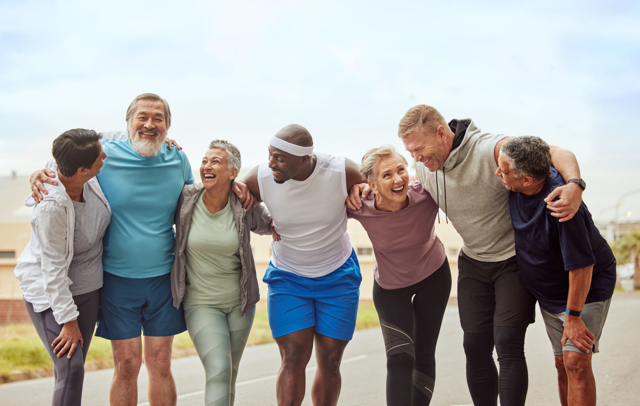Fitness, senior group of people and smile outdoor together for exercise motivation, retirement health support and diversity on training workout. Elderly athletes, happiness hug and sports friends Fitness, senior group of people and smile outdoor together for exercise motivation, retirement health support and diversity on training workout. Elderly athletes, happiness hug and sports friends