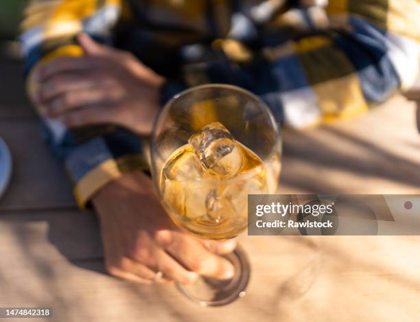 top view of a glass of golden beverage on ice - amaretto liqueur stock pictures, royalty-free photos & images