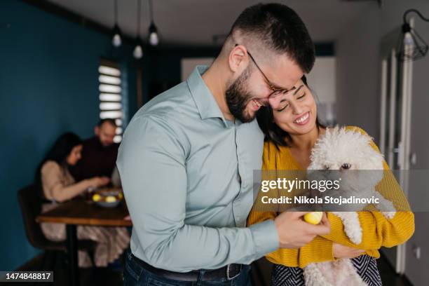 happy couple celebrating easter with their dog - dog easter stock pictures, royalty-free photos & images