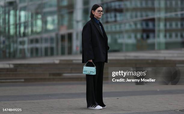 Maria Barteczko seen wearing Victoria Beckham black oversized Aviator glasses, Prada black logo striped tie, The Frankie Shop black oversized blazer,...