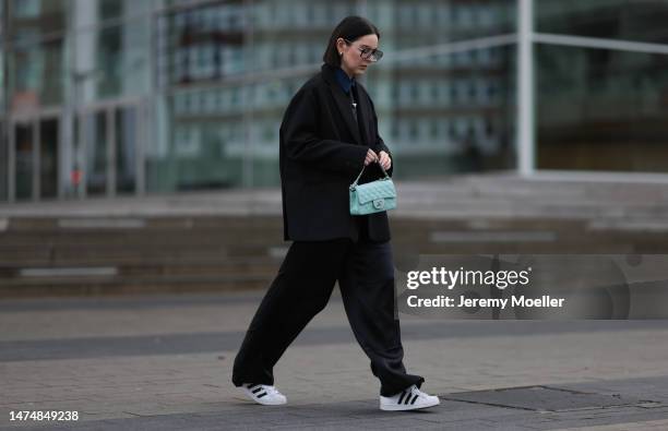 Maria Barteczko seen wearing Victoria Beckham black oversized Aviator glasses, Prada black logo striped tie, The Frankie Shop black oversized blazer,...