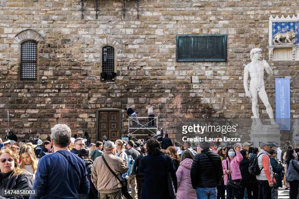 Tourists gather in Piazza della Signoria after protestors from the action group Ultima Generazione smeared Palazzo Vecchio with paint on March 17,...