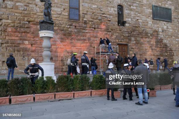 The mayor of Florence Dario Nardella cleans the facade of Palazzo Vecchio after protestors from the action group Ultima Generazione smeared Palazzo...