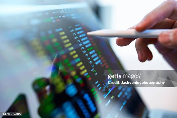 market analyze with digital monitor focus on tip of finger. - bear and bull stock pictures, royalty-free photos & images