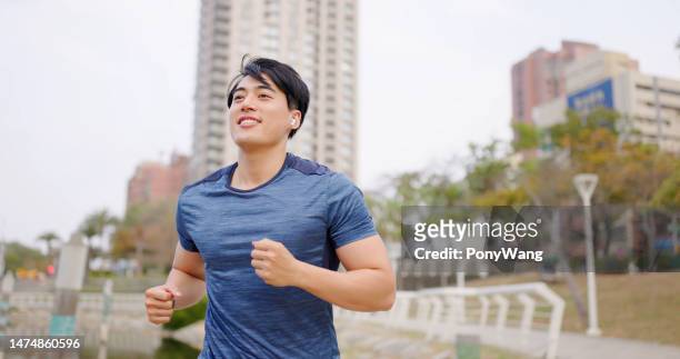 asian man jogging in city - japanese ethnicity the human body stock pictures, royalty-free photos & images