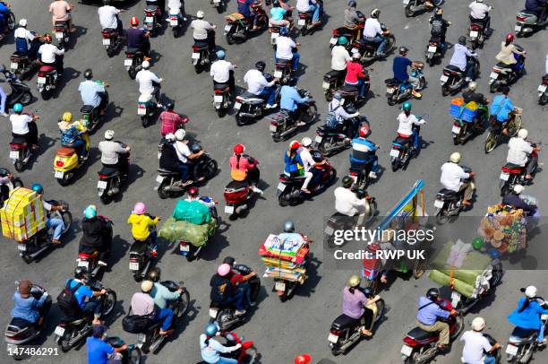 a sea of mopeds during rush hour in central saigon - ho chi minh city stockfoto's en -beelden