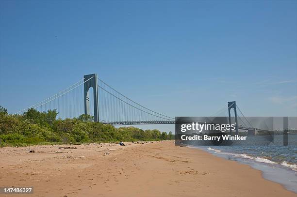 white sand beach, shrubs and suspension bridge. - staten island stock pictures, royalty-free photos & images