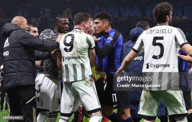 Joaquin Correa of FC Internazionale clashes with Dusan Vlahovic of Juventus FC during the Serie A match between FC Internazionale and Juventus FC at...