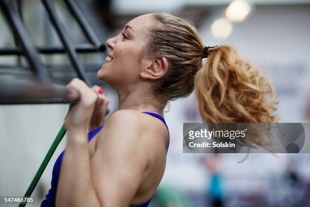 young woman training in gym center - pull ups stock pictures, royalty-free photos & images