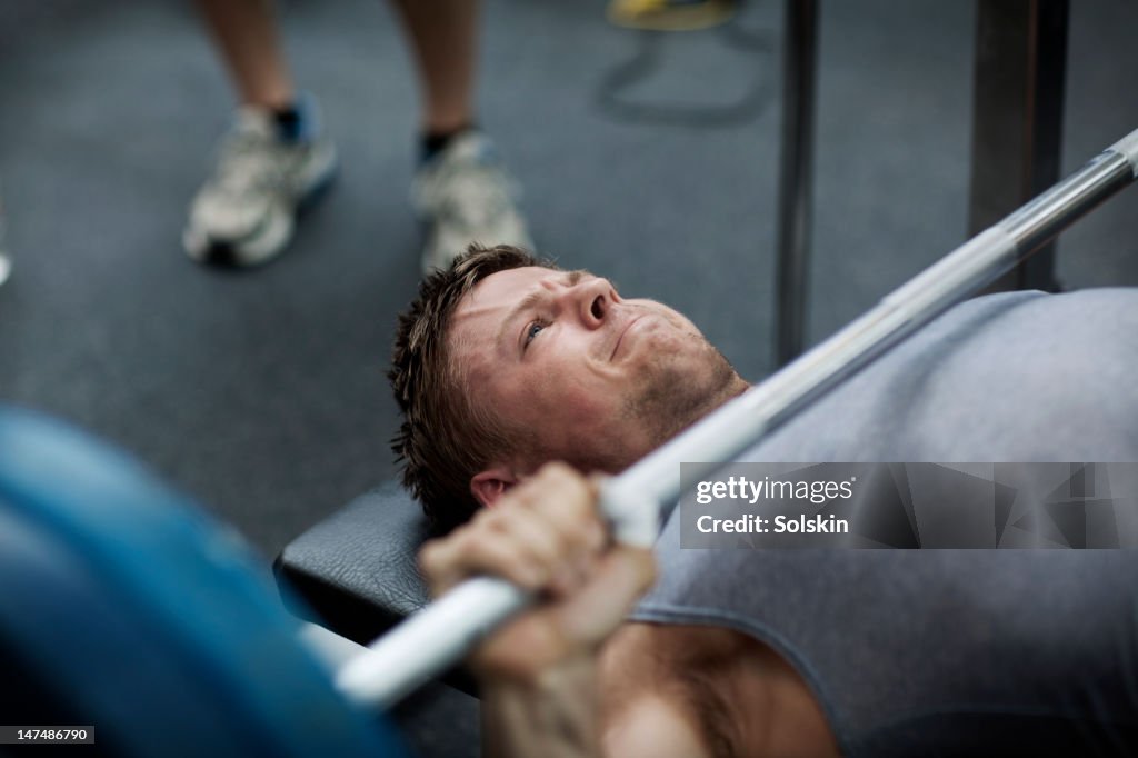 Man doing benchpress in gym