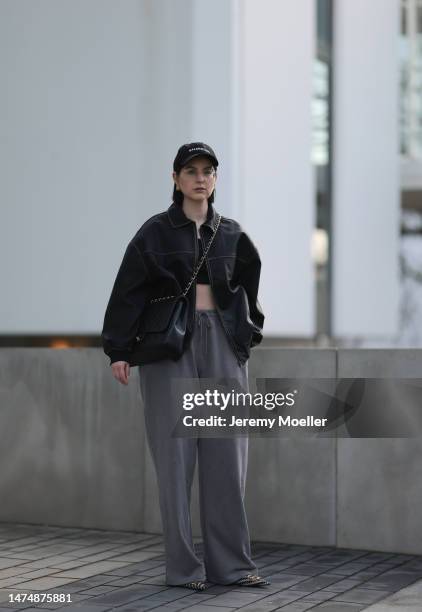 Maria Barteczko seen wearing Ray-Ban gold round retro glasses, Balenciaga gold earrings, Balenciaga black logo baseball cap, Stradivarius black faded...