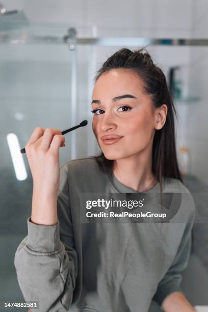 adorable woman applying make up - eye make up stock pictures, royalty-free photos & images