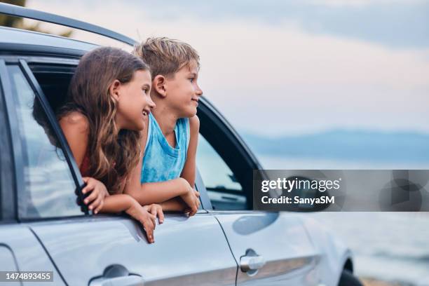 beautiful children in car enjoying summer vacation - family beach vacation stock pictures, royalty-free photos & images
