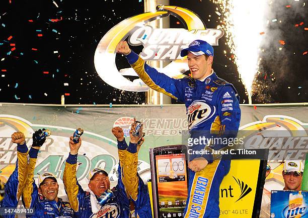 Brad Keselowski, driver of the Miller Lite Dodge, celebrates in Victory Lane after winning the NASCAR Sprint Cup Series Quaker State 400 at Kentucky...
