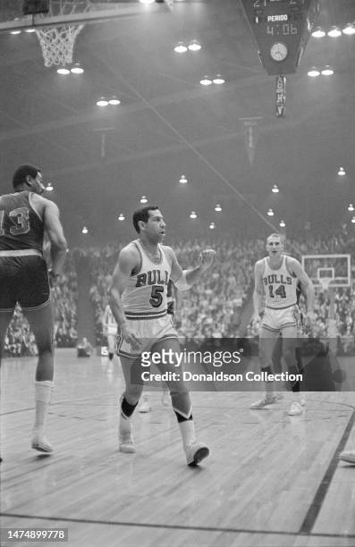 Center Wilt Chamberlain of the Philadelphia 76ers with Guy Rodgers and Erwin Mueller of the Chicago Bulls at the International Amphitheatre on March...