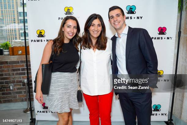 Jacqueline Roman, Trish Valenza and Richard DeAngelo attend PAWS NY Spring Benefit: Barks & Blooms at Monarch Rooftop on May 23, 2022 in New York...