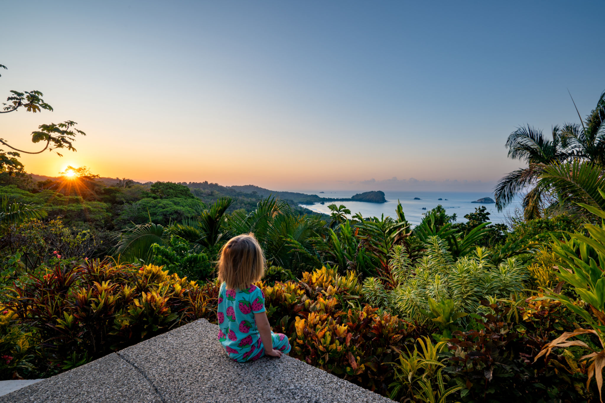 Toddler Girl Enjoying a Vibrant Sunrise over the Wild Untamed Coastal Beauty of Manuel Antonio National Park on the Pacific Coast of Costa Rica Toddler Girl Enjoying a Vibrant Sunrise over the Wild Untamed Coastal Beauty of Manuel Antonio National Park on the Pacific Coast of Costa Rica