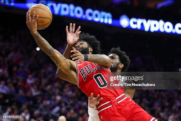 Coby White of the Chicago Bulls shoots a lay up past Joel Embiid of the Philadelphia 76ers during the second quarter at Wells Fargo Center on March...