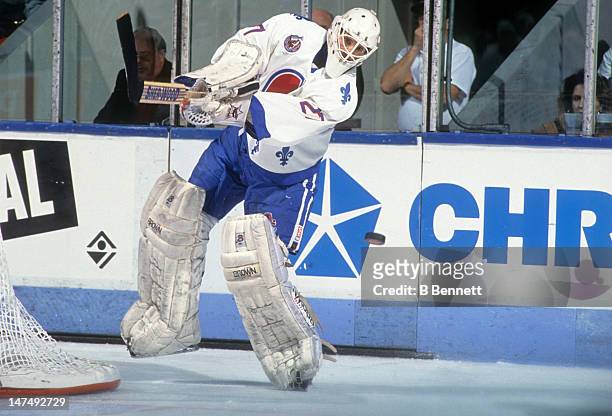 Goalie Ron Hextall of the Quebec Nordiques passes the puck during an NHL game circa 1993 at the Quebec Coliseum in Quebec City, Quebec, Canada.