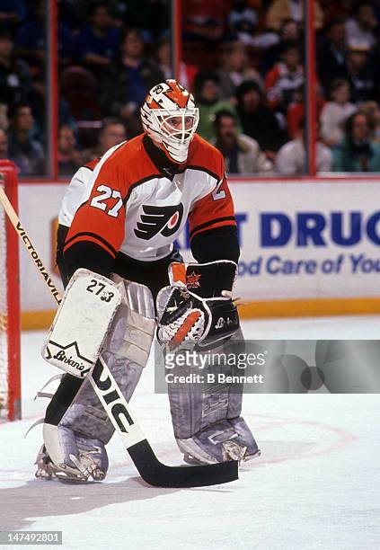 Goalie Ron Hextall of the Philadelphia Flyers defends the net during an NHL game in December, 1990 at the Spectrum in Philadelphia, Pennsylvania.