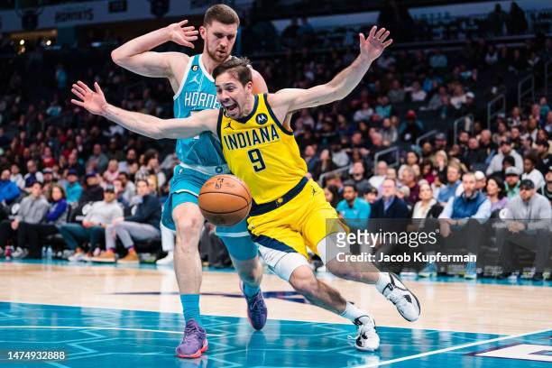 Svi Mykhailiuk of the Charlotte Hornets fouls T.J. McConnell of the Indiana Pacers in the fourth quarter during their game at Spectrum Center on...