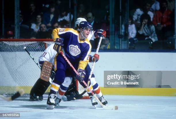 Luc Robitaille of the Los Angeles Kings looks to deflect the shot during an NHL game against the New York Islanders on October 25, 1986 at the Nassau...