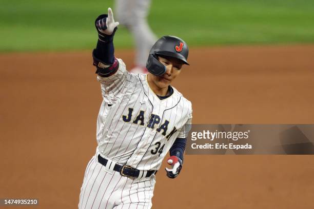 Masataka Yoshida of Team Japan rounds the bases after hitting a three-run home run in the seventh inning against Team Mexico to tie the World...