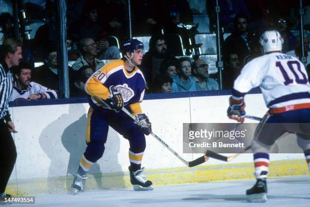Luc Robitaille of the Los Angeles Kings looks for a pass during an NHL game against the New York Islanders on October 25, 1986 at the Nassau Coliseum...