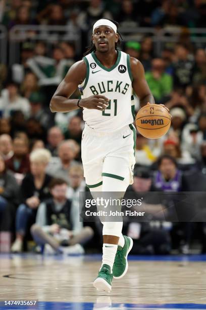 Jrue Holiday of the Milwaukee Bucks dribbles up court during the first half of the game against the Toronto Raptors at Fiserv Forum on March 19, 2023...