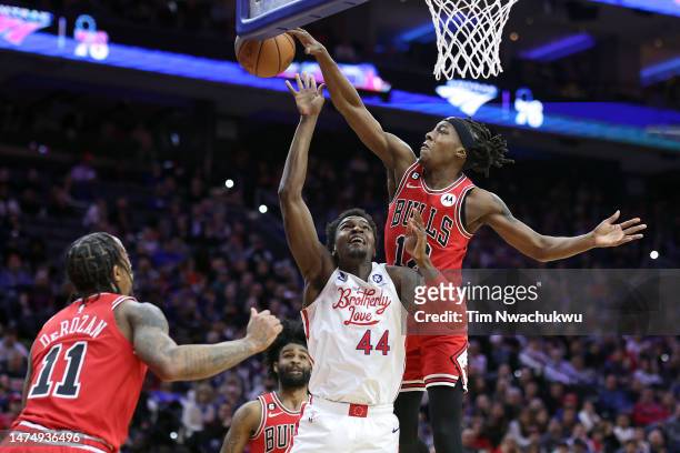 Ayo Dosunmu of the Chicago Bulls blocks Paul Reed of the Philadelphia 76ers during the fourth quarter at Wells Fargo Center on March 20, 2023 in...