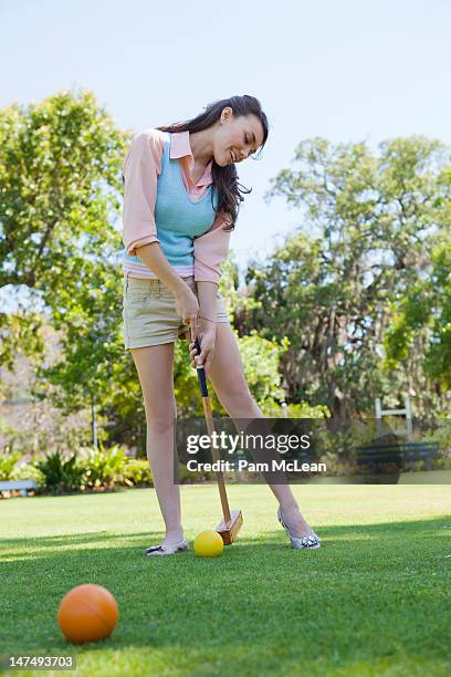 young woman playing croquet - winter park florida stockfoto's en -beelden