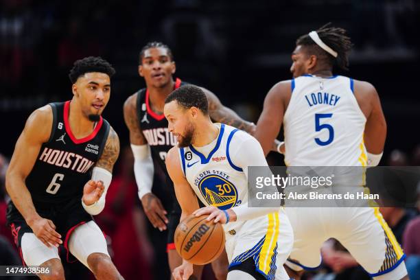Stephen Curry of the Golden State Warriors dribbles the ball against the Houston Rockets during the fourth quarter of the game at Toyota Center on...