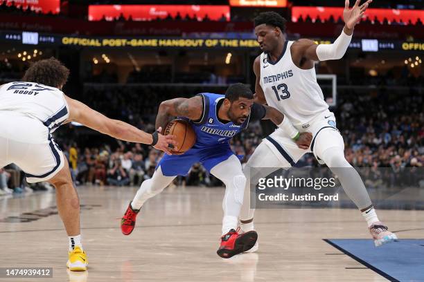 Kyrie Irving of the Dallas Mavericks handles the ball against Jaren Jackson Jr. #13 of the Memphis Grizzlies during the second half at FedExForum on...