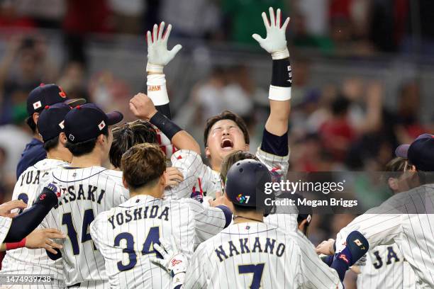 Munetaka Murakami of Team Japan celebrates with teammates after hitting a two-run double to defeat Team Mexico 6-5 in the World Baseball Classic...